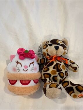 Disney strawberry shortcake, stuffed plushy and Reese’s pieces leopard plushy